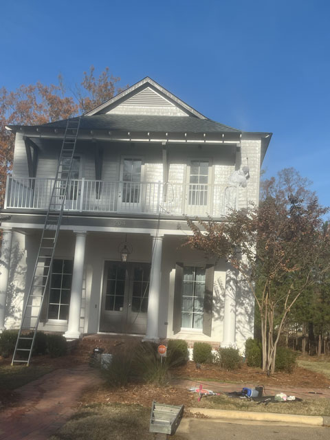 Two-story home exterior repaint in progress
